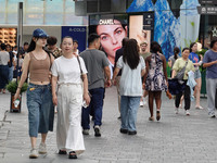 People visit Taikoo Li, a trendy fashion district in Sanlitun, in Beijing, China, on August 18, 2024. (