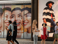 People visit Taikoo Li, a trendy fashion district in Sanlitun, in Beijing, China, on August 18, 2024. (