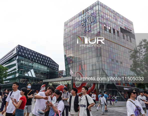 People visit Taikoo Li, a trendy fashion district in Sanlitun, in Beijing, China, on August 18, 2024. 