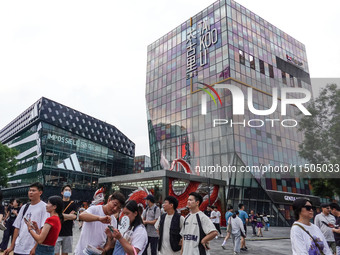 People visit Taikoo Li, a trendy fashion district in Sanlitun, in Beijing, China, on August 18, 2024. (