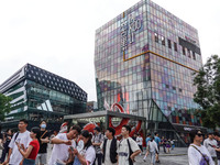 People visit Taikoo Li, a trendy fashion district in Sanlitun, in Beijing, China, on August 18, 2024. (