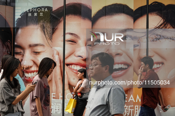 People visit Taikoo Li, a trendy fashion district in Sanlitun, in Beijing, China, on August 18, 2024. 