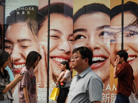 People visit Taikoo Li, a trendy fashion district in Sanlitun, in Beijing, China, on August 18, 2024. (