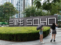 People visit Taikoo Li, a trendy fashion district in Sanlitun, in Beijing, China, on August 18, 2024. (