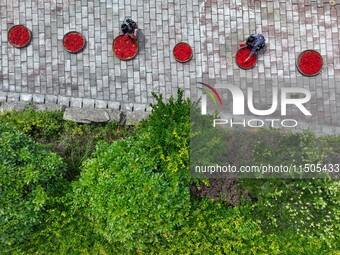 Villagers dry chili peppers and corn in Miaoluo village in Qiandongnan Miao and Dong autonomous Prefecture in Qiandongnan, China, on August...