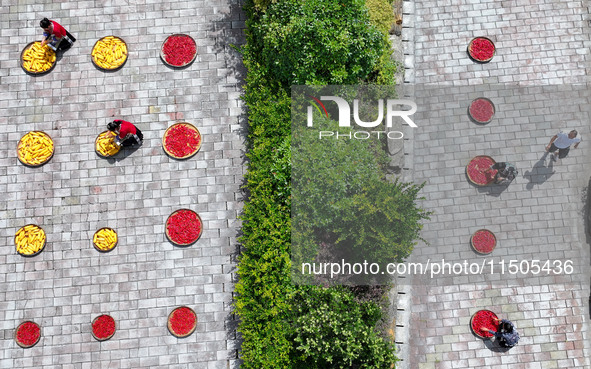 Villagers dry chili peppers and corn in Miaoluo village in Qiandongnan Miao and Dong autonomous Prefecture in Qiandongnan, China, on August...