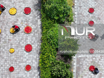 Villagers dry chili peppers and corn in Miaoluo village in Qiandongnan Miao and Dong autonomous Prefecture in Qiandongnan, China, on August...