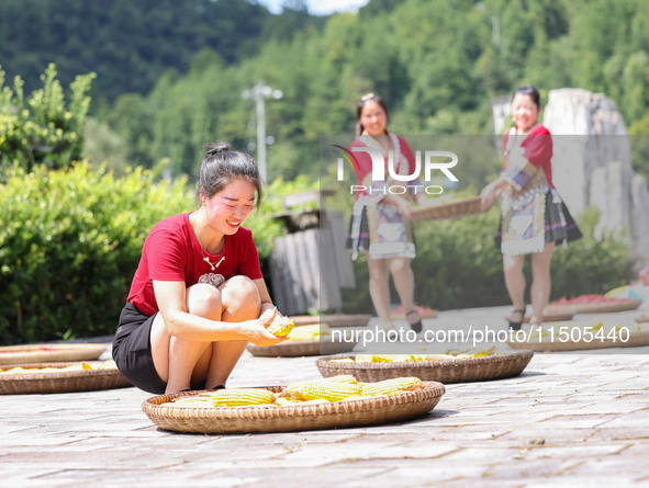 Villagers dry chili peppers and corn in Miaoluo village in Qiandongnan Miao and Dong autonomous Prefecture in Qiandongnan, China, on August...