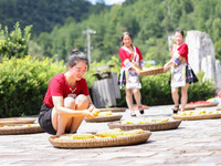 Villagers dry chili peppers and corn in Miaoluo village in Qiandongnan Miao and Dong autonomous Prefecture in Qiandongnan, China, on August...