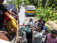 Local volunteers rescue elderly women trapped in floods to safety in Bishumiar Hat, Mirsarai, Bangladesh, in the southeastern region of Bang...