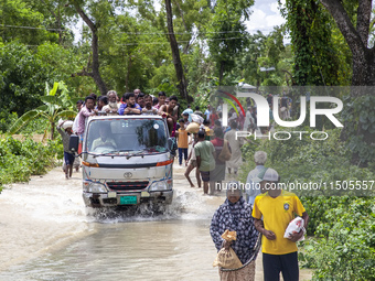 Local volunteers rescue people trapped by floods and take them to safety by car in Bishumia Hat, Mirsarai, southern Bangladesh, in Mirsarai,...