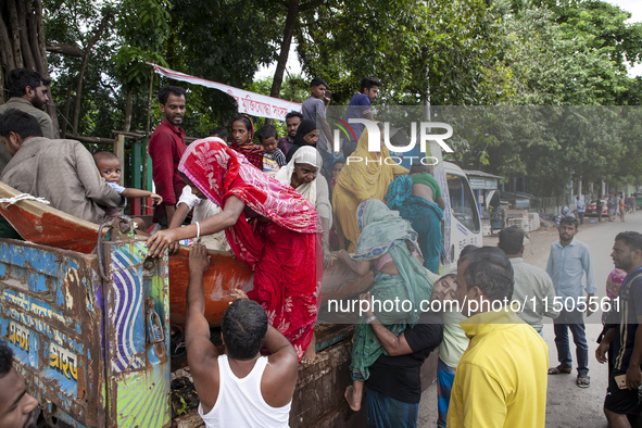 Local volunteers rescue elderly women trapped in floods to safety in Bishumiar Hat, Mirsarai, Bangladesh, in the southeastern region of Bang...