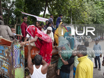 Local volunteers rescue elderly women trapped in floods to safety in Bishumiar Hat, Mirsarai, Bangladesh, in the southeastern region of Bang...