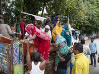 Local volunteers rescue elderly women trapped in floods to safety in Bishumiar Hat, Mirsarai, Bangladesh, in the southeastern region of Bang...