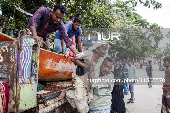 Local volunteers rescue elderly women trapped in floods to safety in Bishumiar Hat, Mirsarai, Bangladesh, in the southeastern region of Bang...