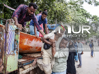 Local volunteers rescue elderly women trapped in floods to safety in Bishumiar Hat, Mirsarai, Bangladesh, in the southeastern region of Bang...