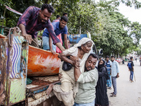 Local volunteers rescue elderly women trapped in floods to safety in Bishumiar Hat, Mirsarai, Bangladesh, in the southeastern region of Bang...