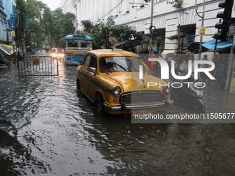 Vehicles drive through a flooded street during the heavy monsoon rain in Kolkata, India, on August 24, 2024. (