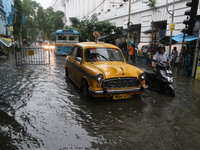 Vehicles drive through a flooded street during the heavy monsoon rain in Kolkata, India, on August 24, 2024. (