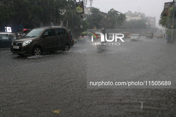 Vehicles drive through a flooded street during the heavy monsoon rain in Kolkata, India, on August 24, 2024. 