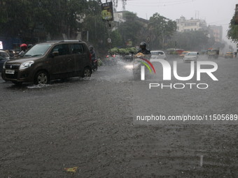 Vehicles drive through a flooded street during the heavy monsoon rain in Kolkata, India, on August 24, 2024. (