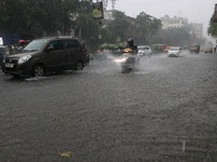 Vehicles drive through a flooded street during the heavy monsoon rain in Kolkata, India, on August 24, 2024. (