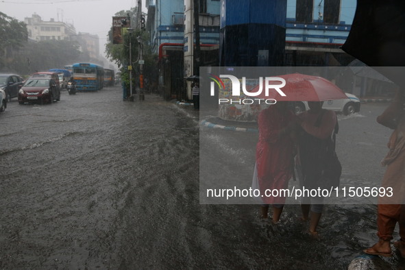 Vehicles drive through a flooded street during the heavy monsoon rain in Kolkata, India, on August 24, 2024. 