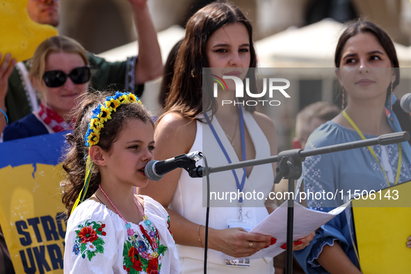 Members of Ukrainian diaspora chant slogans and hold Ukrainian flags during a demonstration on Ukrainian Independence Day  on the Main Squar...