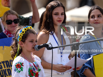 Members of Ukrainian diaspora chant slogans and hold Ukrainian flags during a demonstration on Ukrainian Independence Day  on the Main Squar...