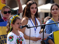 Members of Ukrainian diaspora chant slogans and hold Ukrainian flags during a demonstration on Ukrainian Independence Day  on the Main Squar...