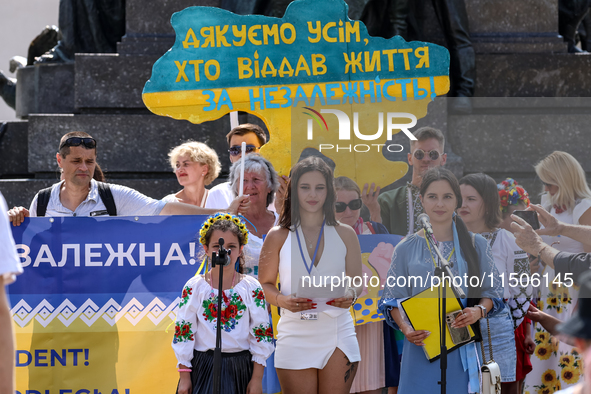 Members of Ukrainian diaspora chant slogans and hold Ukrainian flags during a demonstration on Ukrainian Independence Day  on the Main Squar...