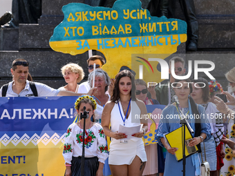 Members of Ukrainian diaspora chant slogans and hold Ukrainian flags during a demonstration on Ukrainian Independence Day  on the Main Squar...