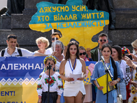 Members of Ukrainian diaspora chant slogans and hold Ukrainian flags during a demonstration on Ukrainian Independence Day  on the Main Squar...