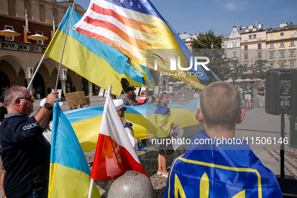 Members of Ukrainian diaspora chant slogans and hold Ukrainian flags during a demonstration on Ukrainian Independence Day  on the Main Squar...