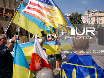 Members of Ukrainian diaspora chant slogans and hold Ukrainian flags during a demonstration on Ukrainian Independence Day  on the Main Squar...