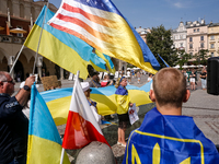 Members of Ukrainian diaspora chant slogans and hold Ukrainian flags during a demonstration on Ukrainian Independence Day  on the Main Squar...