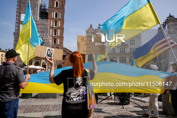 Members of Ukrainian diaspora chant slogans and hold Ukrainian flags during a demonstration on Ukrainian Independence Day  on the Main Squar...