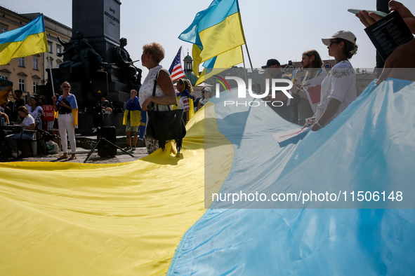 Members of Ukrainian diaspora chant slogans and hold Ukrainian flags during a demonstration on Ukrainian Independence Day  on the Main Squar...