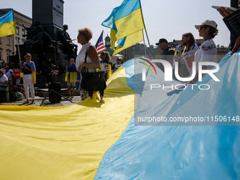 Members of Ukrainian diaspora chant slogans and hold Ukrainian flags during a demonstration on Ukrainian Independence Day  on the Main Squar...