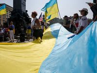 Members of Ukrainian diaspora chant slogans and hold Ukrainian flags during a demonstration on Ukrainian Independence Day  on the Main Squar...