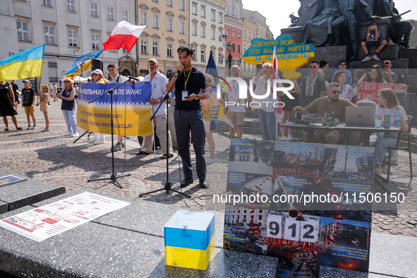 Members of Ukrainian diaspora chant slogans and hold Ukrainian flags during a demonstration on Ukrainian Independence Day  on the Main Squar...