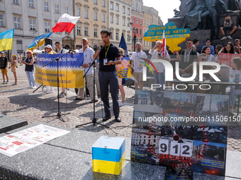 Members of Ukrainian diaspora chant slogans and hold Ukrainian flags during a demonstration on Ukrainian Independence Day  on the Main Squar...