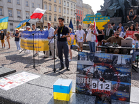 Members of Ukrainian diaspora chant slogans and hold Ukrainian flags during a demonstration on Ukrainian Independence Day  on the Main Squar...