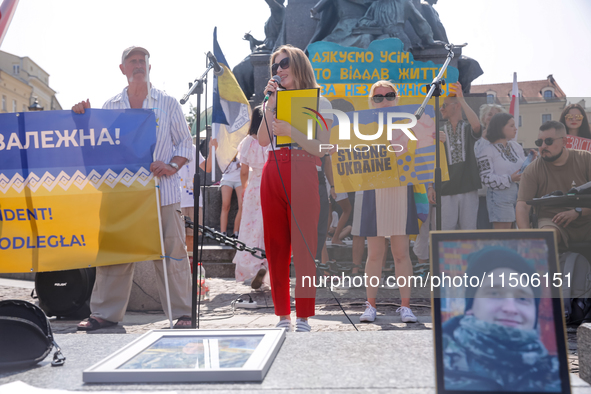 Members of Ukrainian diaspora chant slogans and hold Ukrainian flags during a demonstration on Ukrainian Independence Day  on the Main Squar...