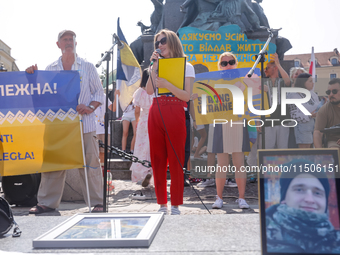 Members of Ukrainian diaspora chant slogans and hold Ukrainian flags during a demonstration on Ukrainian Independence Day  on the Main Squar...