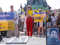 Members of Ukrainian diaspora chant slogans and hold Ukrainian flags during a demonstration on Ukrainian Independence Day  on the Main Squar...