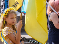 Members of Ukrainian diaspora chant slogans and hold Ukrainian flags during a demonstration on Ukrainian Independence Day  on the Main Squar...