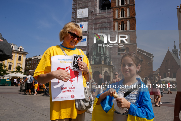 Members of Ukrainian diaspora chant slogans and hold Ukrainian flags during a demonstration on Ukrainian Independence Day  on the Main Squar...