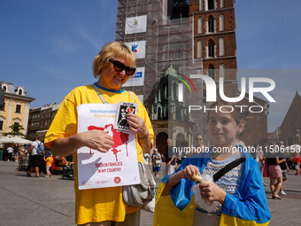 Members of Ukrainian diaspora chant slogans and hold Ukrainian flags during a demonstration on Ukrainian Independence Day  on the Main Squar...