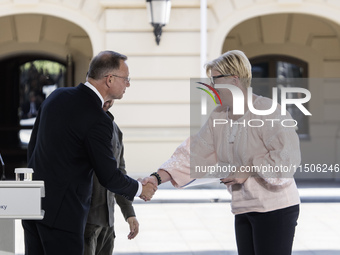 Polish President Andrzej Duda and Lithuanian Prime Minister Ingrida Simonyte shake hands after a joint press conference with Ukraine's Presi...